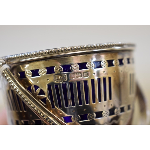 14 - A pierced silver sugar basket, by L & W, Birmingham 1911, 11cm high, 99g.... 