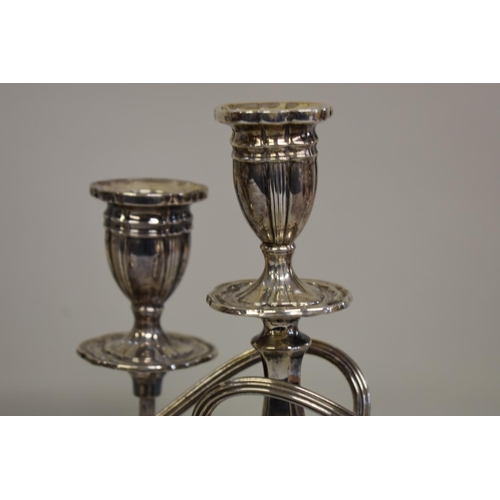 18 - A pair of silver twin branch candelabra, by Alexander Smith, Birmingham 1976, 27.5cm high.... 