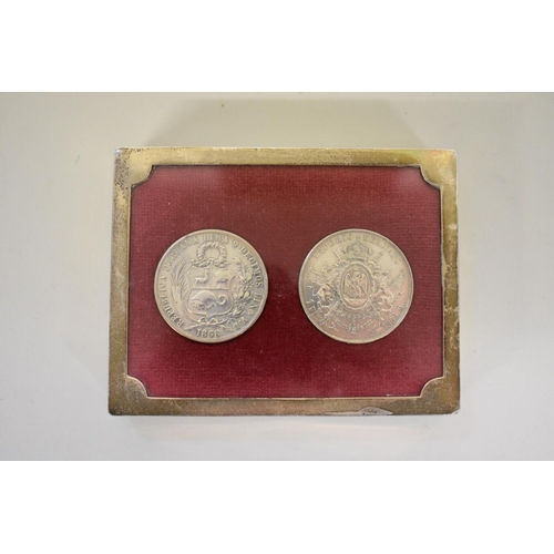 282 - A 1868 Peruvian silver one Sol and an 1866 Mexican silver one Peso, mounted in silver frame, by Guy ... 