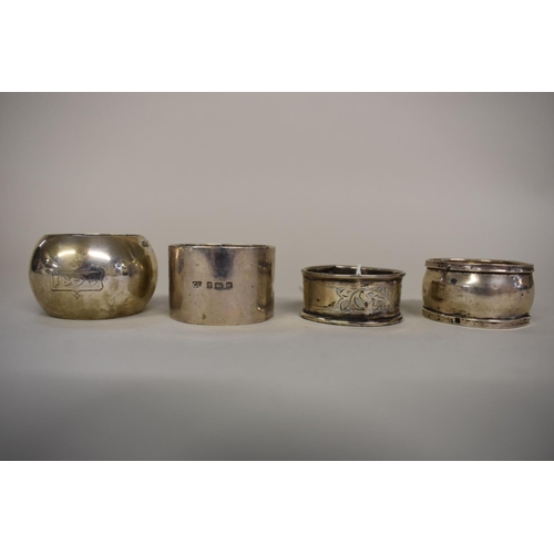 65 - Three various silver napkin rings, 103g; together with one other.