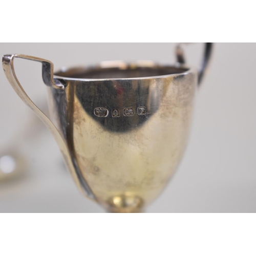 66 - A small silver trophy cup; together with other silver and metal items.