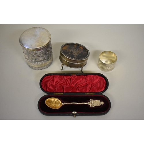 68 - Four items of silver, to include: a cased souvenir spoon; a silver and tortoiseshell casket; a napki... 