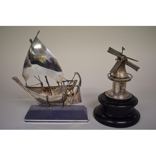 73 - A model of a Greek sailboat, stamped sterling 925; together with model windmill on wooden plinth.... 