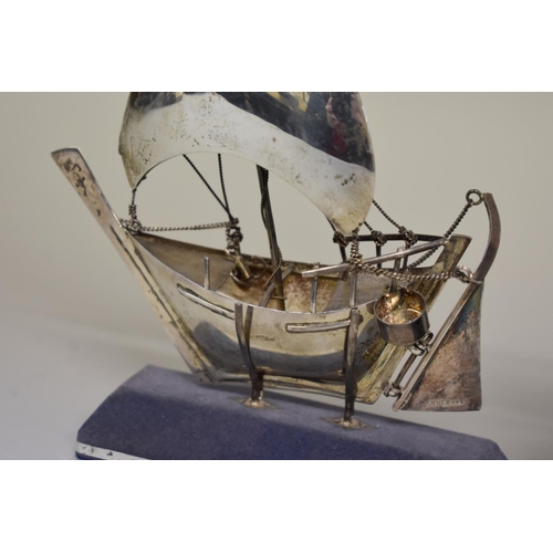 73 - A model of a Greek sailboat, stamped sterling 925; together with model windmill on wooden plinth.... 