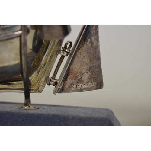 73 - A model of a Greek sailboat, stamped sterling 925; together with model windmill on wooden plinth.... 