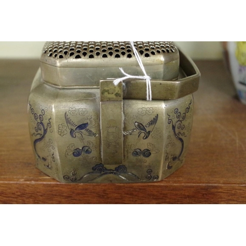 557 - A Chinese paktong handwarmer, 18th/19th century, of chamfered rectangular form, chased with animals ... 