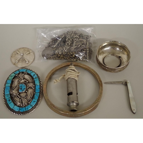 110 - A group of silver and metal items, to include: a Native American buckle; and silver chains.... 