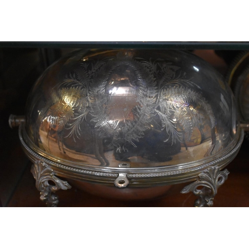 135 - A collection of silver plate, to include: a pair of bottle coasters; a dome top breakfast dish; a de... 