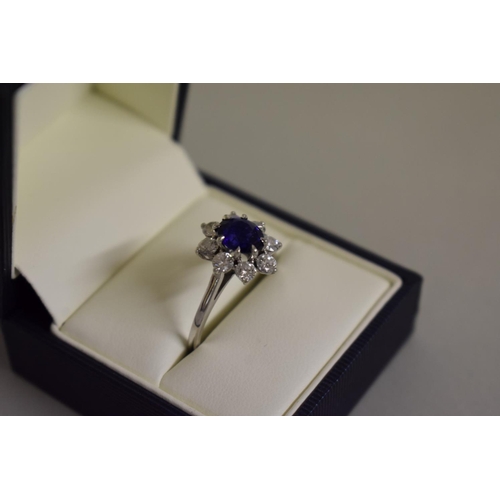 279 - A Cartier oval sapphire and diamond high carat white gold ring, boxed.