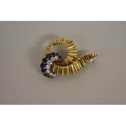 290 - A gold, diamond and sapphire swirl brooch, hallmarked 18ct, 1964, 4cm width, 12g all in.... 