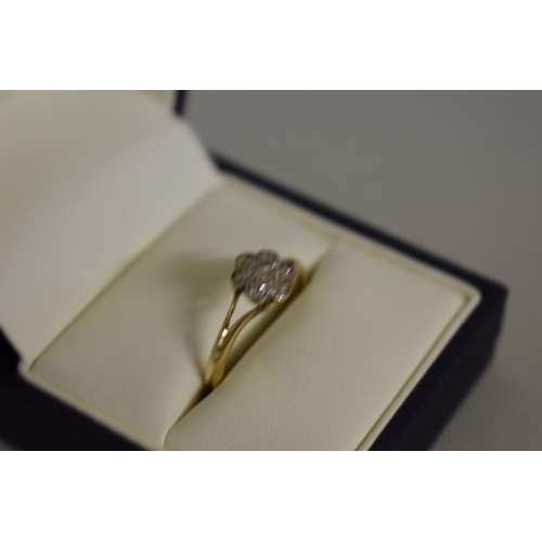 276 - A gold diamond daisy ring, stamped 18ct.... 