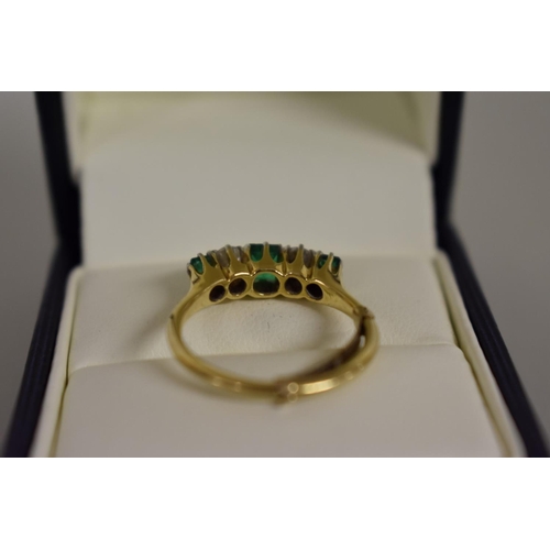 277 - A emerald and diamond five stone gold ring, hallmarked 18ct.... 