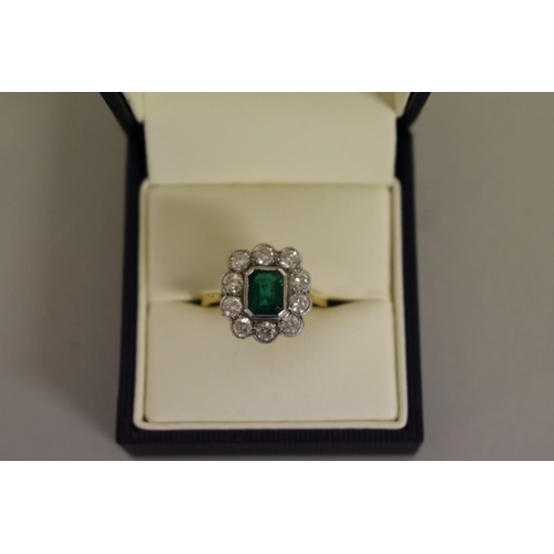 278 - An emerald and diamond gold cluster ring, hallmarked .750/18ct, 4.5g all in.