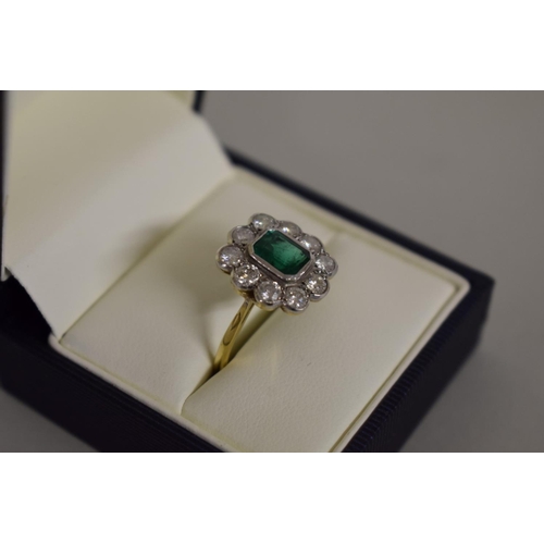 278 - An emerald and diamond gold cluster ring, hallmarked .750/18ct, 4.5g all in.