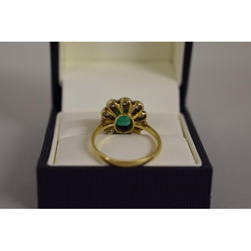 278 - An emerald and diamond gold cluster ring, hallmarked .750/18ct, 4.5g all in.