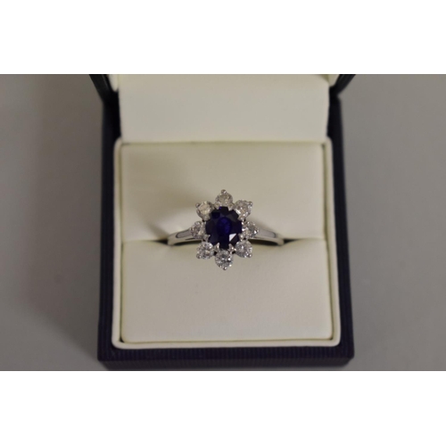 279 - A Cartier oval sapphire and diamond high carat white gold ring, boxed.