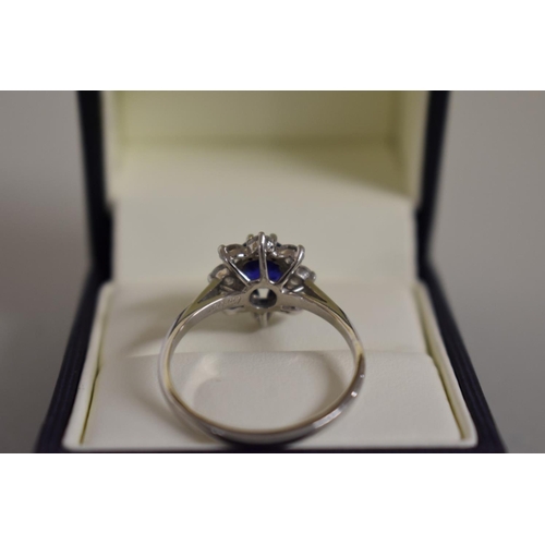 279 - A Cartier oval sapphire and diamond high carat white gold ring, boxed.