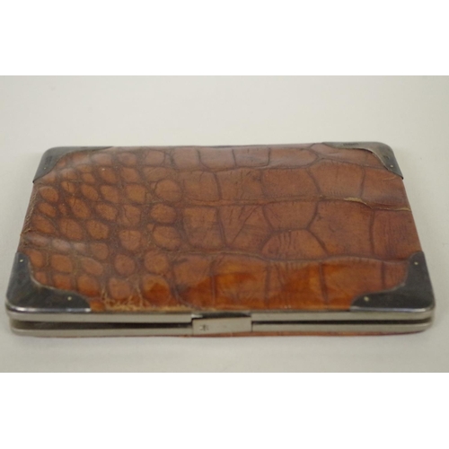 41A - A crocodile wallet, having silver mounted corners by Franz Schiebner, London circa 1900, the interio... 