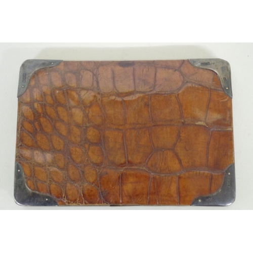 41A - A crocodile wallet, having silver mounted corners by Franz Schiebner, London circa 1900, the interio... 