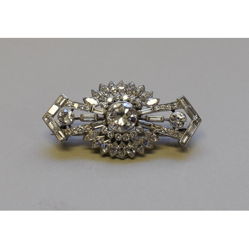 298 - An Art Deco old European cut diamond brooch, the central stone of approximately 2ct, flanked by two ...