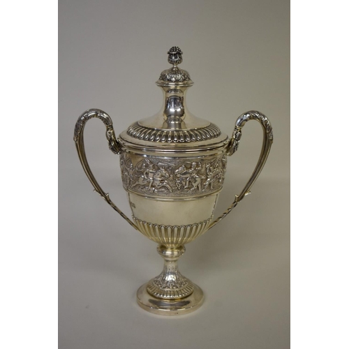 17 - A silver twin handled cup and cover, by C S Harris & Sons Ltd, London 1914, the frieze depicting... 