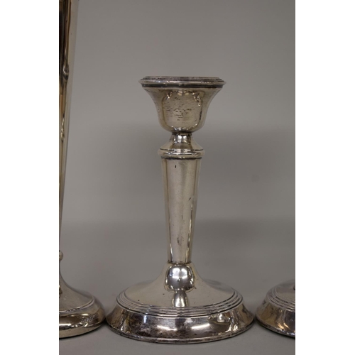 60 - A pair of silver candlesticks, by Henry Perkins & Sons, London 1919, 11cms high; toget... 