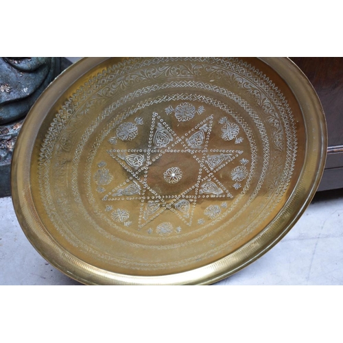 1271 - Three Eastern brass circular trays, largest 58.5cm diameter. 