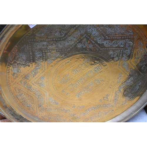 1271 - Three Eastern brass circular trays, largest 58.5cm diameter. 