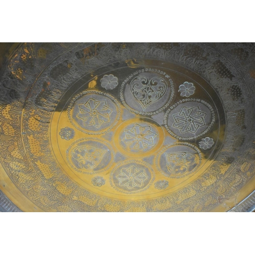 1271 - Three Eastern brass circular trays, largest 58.5cm diameter. 