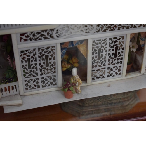 1273 - A Chinese carved and pierced bone model of a boat, 33cm long, in a glazed display case.... 