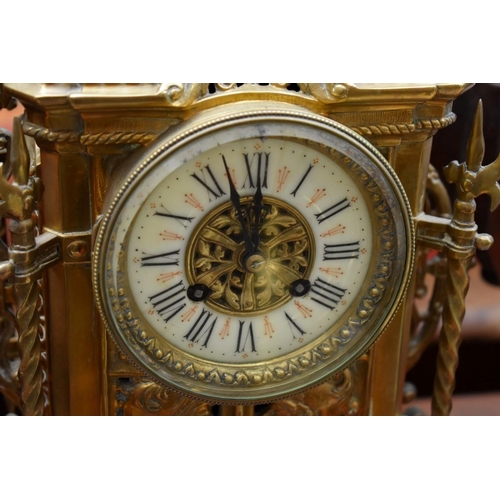 1277 - A brass mantel clock, 50cm high, with pendulum.