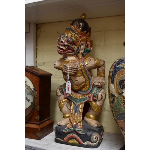 1291 - A Balinese carved and polychrome painted mythical figure, 50cm high.