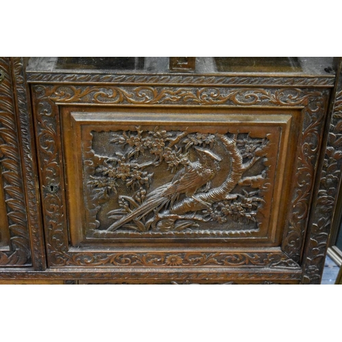 1341 - An unusual late 19th century Chinese carved walnut mirror back side cabinet, 107cm wide.... 