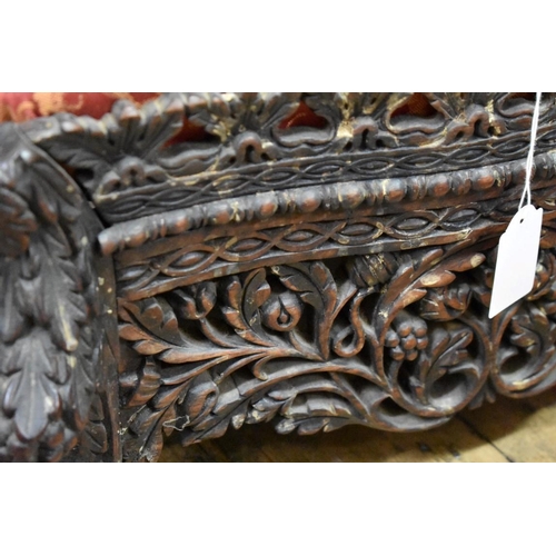 1424 - A 19th century Anglo-Indian carved and pierced hardwood foot stool.