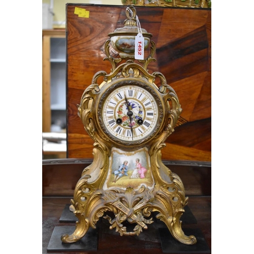 1452 - A late 19th century gilt metal and porcelain mounted clock garniture, the clock 42.5cm high, wi... 