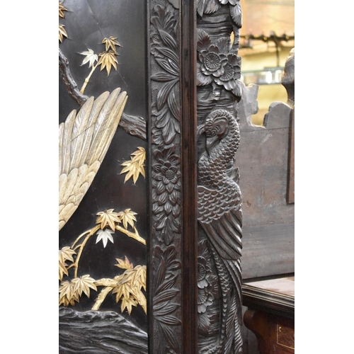 1469 - A large late 19th century Japanese carved wood and shibyama two fold screen, decorated in high relie... 