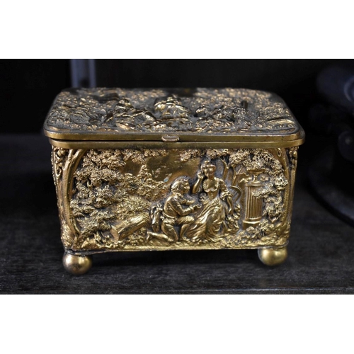 1522 - An antique Continental gilt metal casket, relief moulded with figures in a landscape, 13cm wide; tog... 