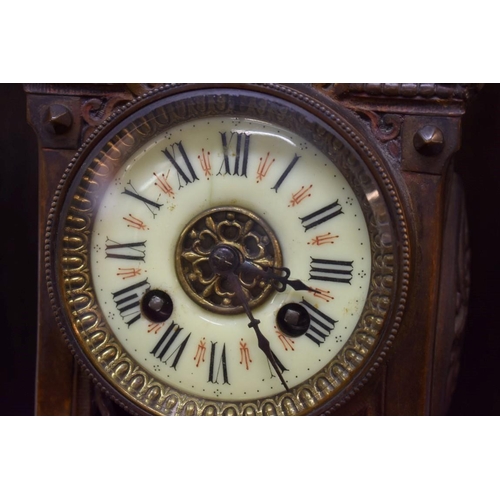 1581 - A late 19th century cast and pierced brass clock, 24.5cm high, with winding key. ... 