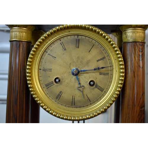 1592 - A 19th century rosewood and inlaid portico clock, 41.5cm high, with pendulum. ... 