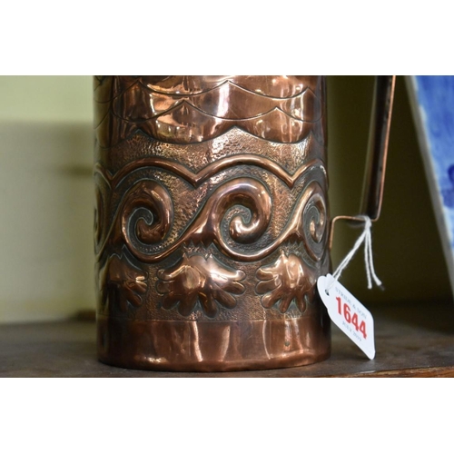 1644 - An Art Nouveau Newlyn or Hayle embossed copper tankard, decorated with stylised boats and scrol... 