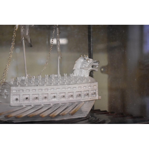 1659 - Two Chinese unmarked metal models of boats, largest 21cm long, each in glazed display case.... 