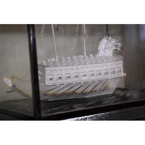 1659 - Two Chinese unmarked metal models of boats, largest 21cm long, each in glazed display case.... 