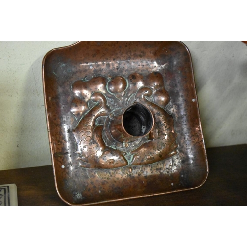 1670 - A Newlyn copper chamberstick, stamped mark, embossed with two stylised fish, 22.5cm long.... 