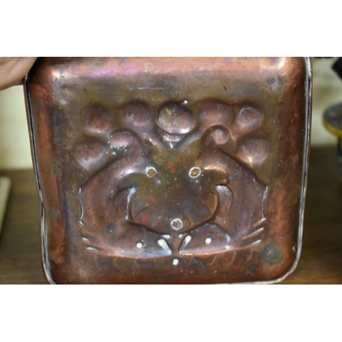 1670 - A Newlyn copper chamberstick, stamped mark, embossed with two stylised fish, 22.5cm long.... 