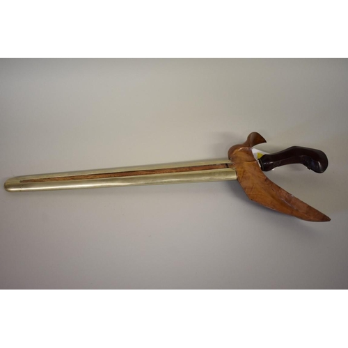 1691 - An Indonesian kris, having 34cm blade, with carved wooden handle, in metal mounted wooden sheath.... 