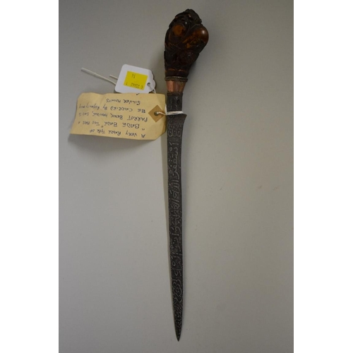 1720 - An Indonesian bade bade knife, having 23cm script inscribed blade, with carved wood parrot head pomm... 