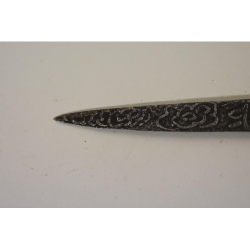 1720 - An Indonesian bade bade knife, having 23cm script inscribed blade, with carved wood parrot head pomm... 