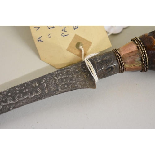 1720 - An Indonesian bade bade knife, having 23cm script inscribed blade, with carved wood parrot head pomm... 