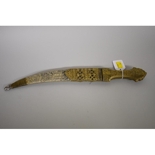 1724 - An Arab jambiya, having pierced 24cm blade, with sheath.