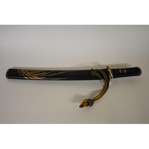 1735 - A Japanese Wakizashi sword, having 30cm fullered blade, signed to tang, with black and gilt lacquere... 